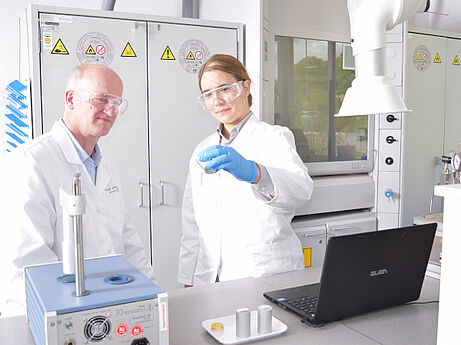Two persons in a service laboratory disussing abour a pour point sample.